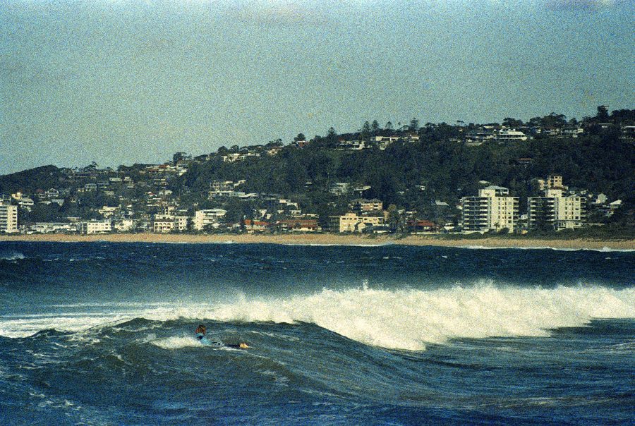 Surfer riding a wave at North Narrabeen Beach