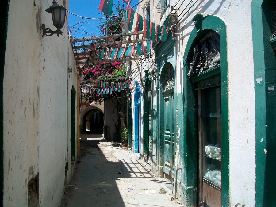 A narrow street in Tripoli’s medina with traditional buildings.