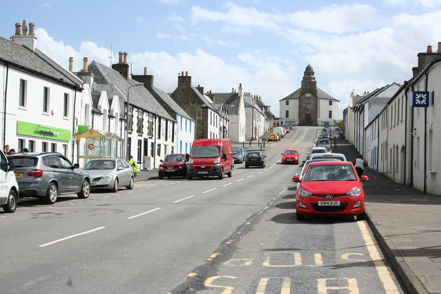 Main Street in Bowmore auf Islay mit der Kilarrow Parish Church am Ende der Straße