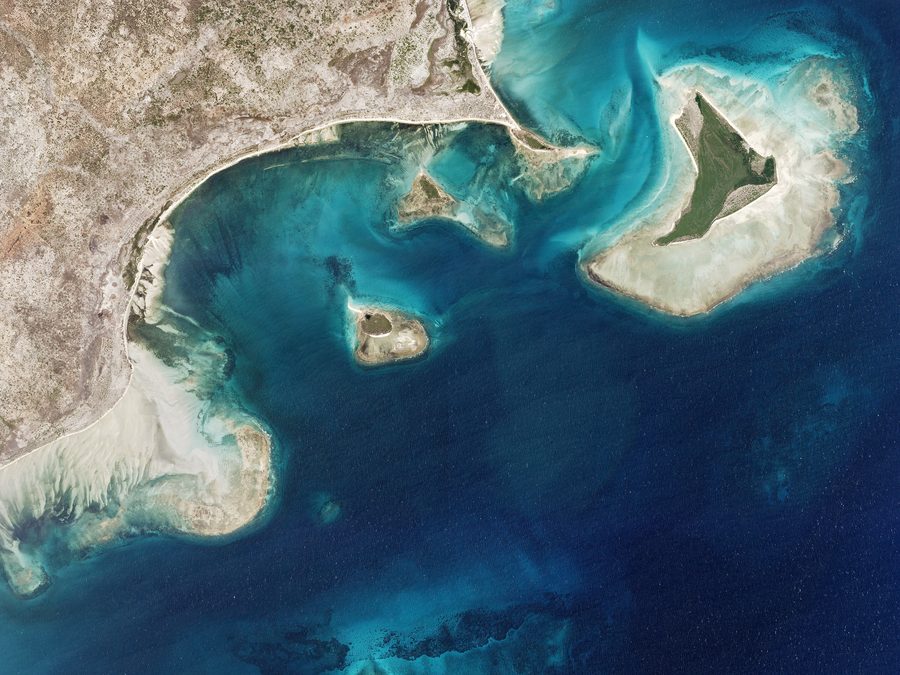 Aerial view of Pangane, a coastal fishing village in Cabo Delgado, Mozambique, with sandbars, small islands, and mangroves.